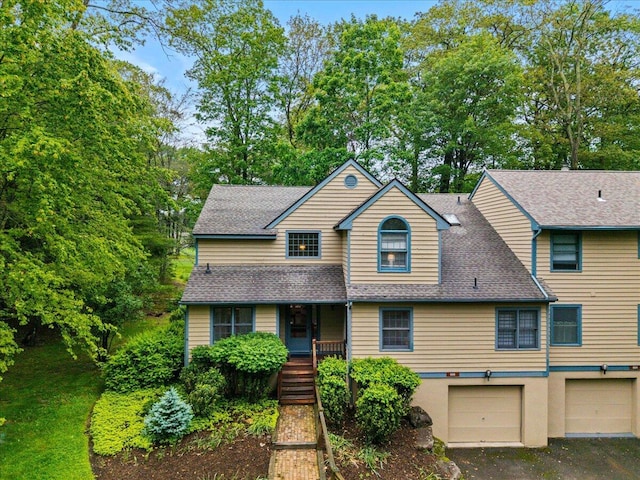 606 Buck Cir, Buck Hill Falls, PA 18323 - view of front of property featuring an attached garage, roof with shingles, covered porch, and stairs