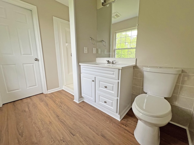 2138 Hill Rd, Effort, PA 18330 - bathroom with wood finished floors, vanity, tile walls, and wainscoting