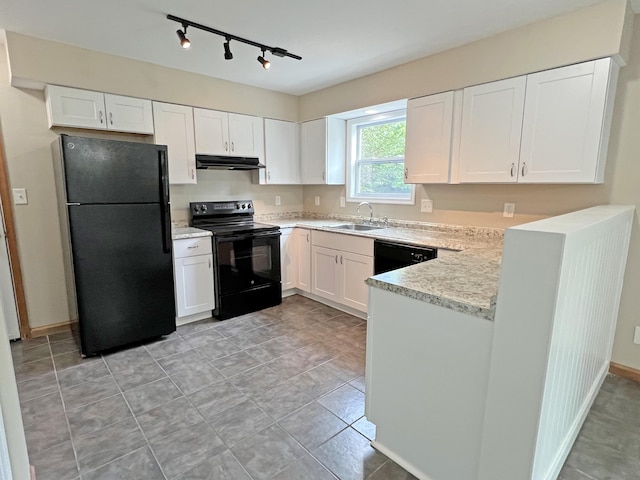 2138 Hill Rd, Effort, PA 18330 - kitchen with black appliances, under cabinet range hood, track lighting, white cabinetry, and light stone countertops