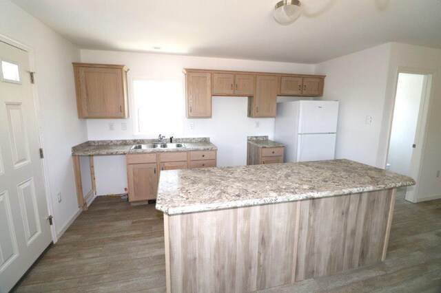 1025 W Princeton Ave, Palmerton, PA 18071 - kitchen featuring freestanding refrigerator, wood finished floors, a kitchen island, and light stone countertops
