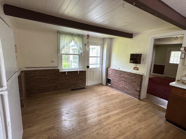 337 Summit Rd, Swiftwater, PA 18370 - interior space with freestanding refrigerator, light wood-type flooring, brick wall, light countertops, and a wood ceiling with exposed beams