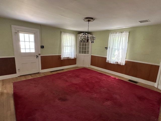 337 Summit Rd, Swiftwater, PA 18370 - unfurnished dining area with a wainscoted wall, a chandelier, wood finished floors, and wooden walls