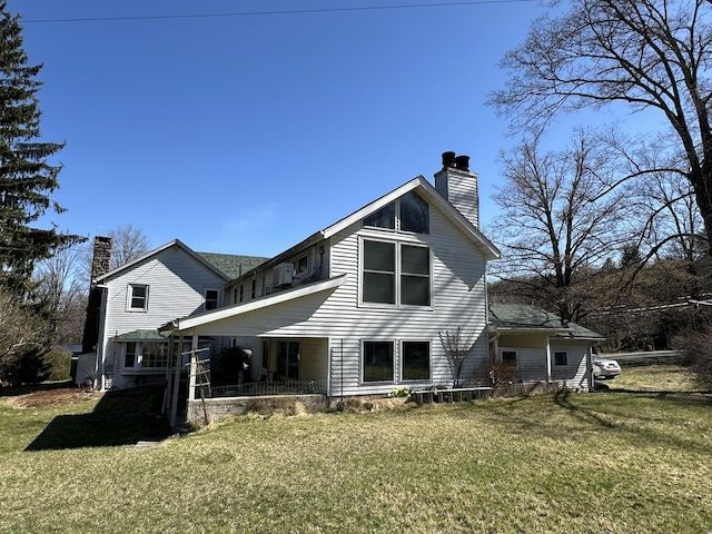 337 Summit Rd, Swiftwater, PA 18370 - rear view of property featuring a chimney, a yard, and covered porch