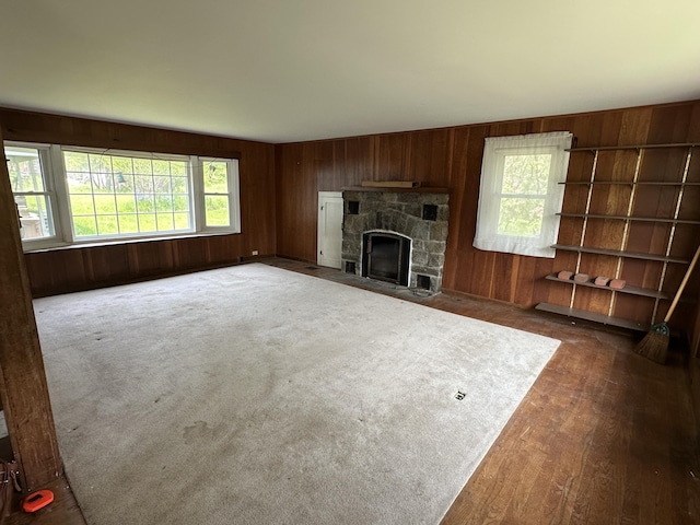 337 Summit Rd, Swiftwater, PA 18370 - unfurnished living room with wooden walls, plenty of natural light, and a stone fireplace