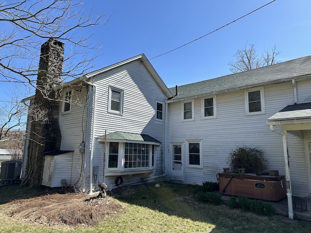 337 Summit Rd, Swiftwater, PA 18370 - rear view of house with a hot tub, a yard, and a chimney