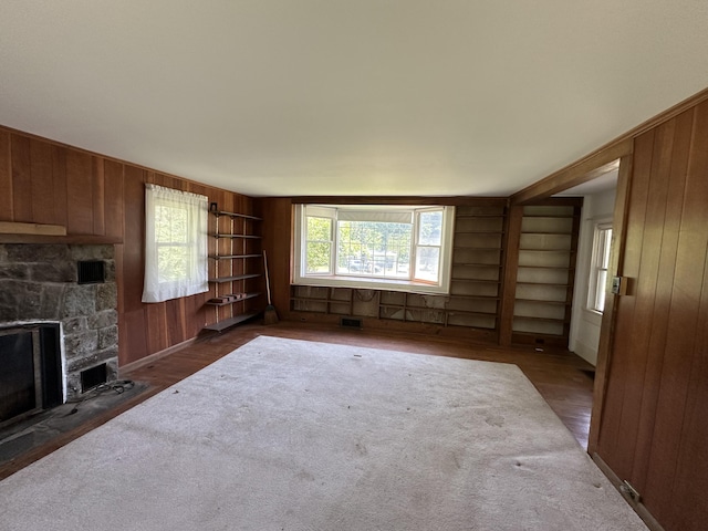 337 Summit Rd, Swiftwater, PA 18370 - unfurnished living room with wood walls, built in features, and a fireplace