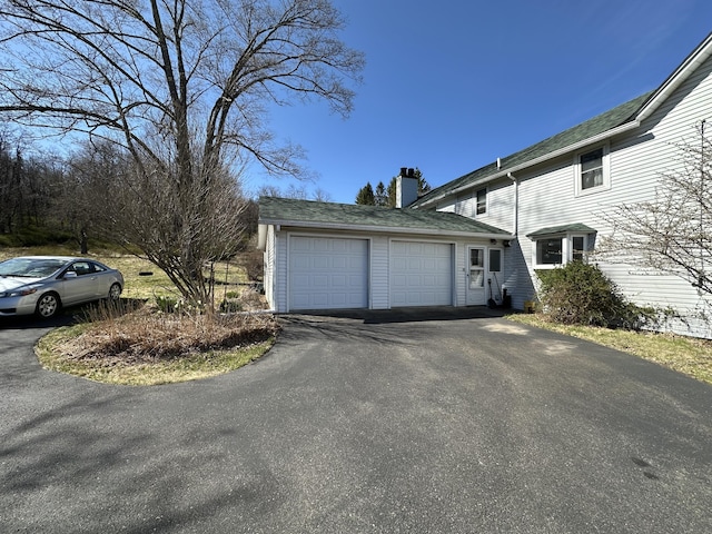 337 Summit Rd, Swiftwater, PA 18370 - view of side of home with a chimney, driveway, and a garage