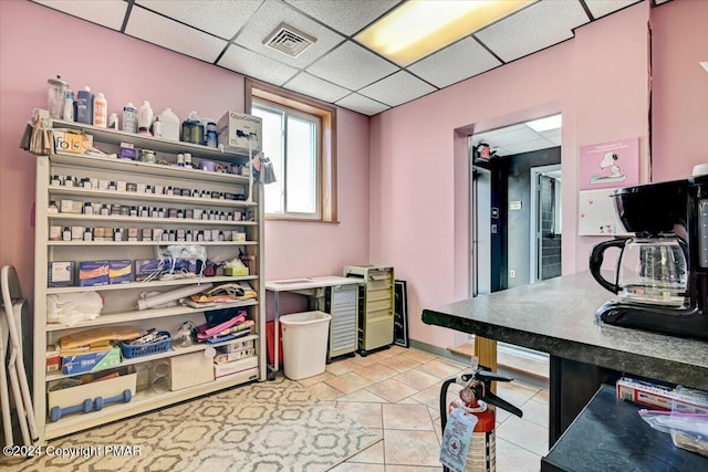 office space featuring a paneled ceiling, visible vents, and baseboards