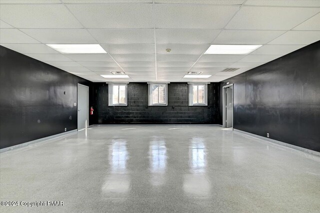 unfurnished room with a paneled ceiling, baseboards, and visible vents