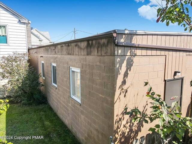 view of home's exterior with concrete block siding