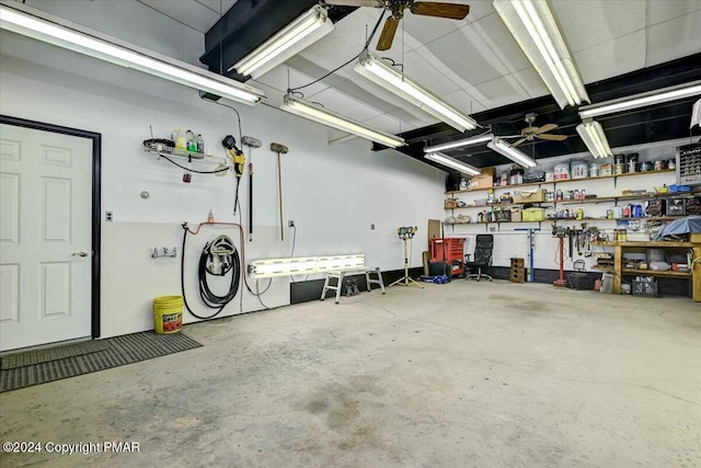 garage featuring a workshop area and a ceiling fan