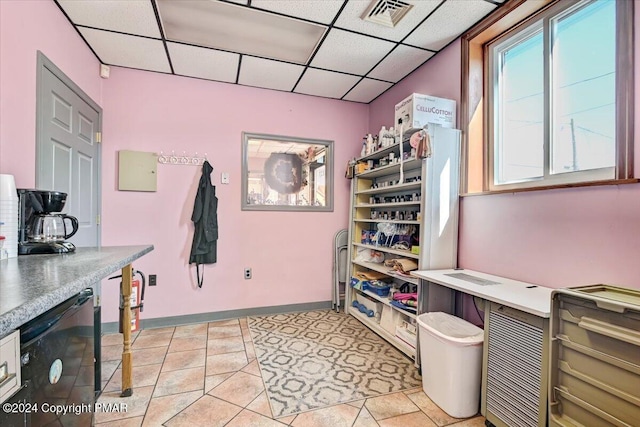 office featuring visible vents, light tile patterned floors, a paneled ceiling, and baseboards