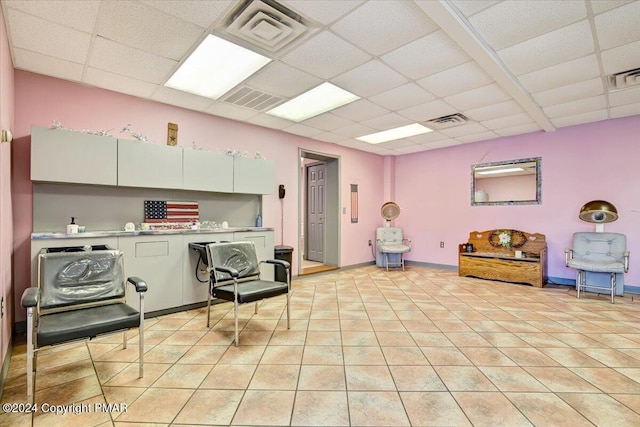 kitchen with a paneled ceiling, light tile patterned flooring, visible vents, and white cabinetry