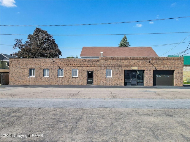 view of front property featuring a garage and brick siding