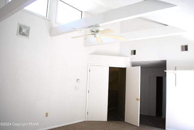 unfurnished bedroom featuring a ceiling fan, visible vents, carpet floors, and high vaulted ceiling