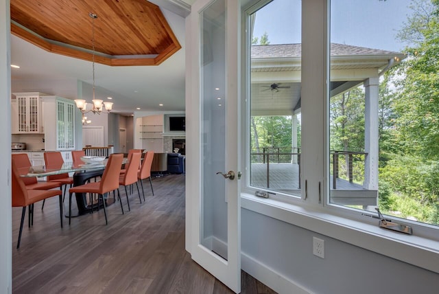 177 Wolf Hollow Rd, Lake Harmony, PA 18624 - dining area featuring a raised ceiling, dark wood finished floors, a wealth of natural light, and a fireplace