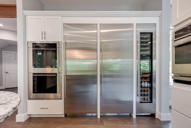 177 Wolf Hollow Rd, Lake Harmony, PA 18624 - kitchen featuring white cabinets, dark wood-type flooring, and appliances with stainless steel finishes
