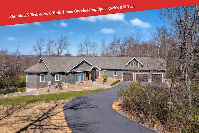 177 Wolf Hollow Rd, Lake Harmony, PA 18624 - craftsman-style house featuring a chimney, driveway, stone siding, a garage, and roof with shingles