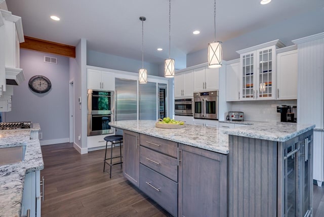 177 Wolf Hollow Rd, Lake Harmony, PA 18624 - kitchen featuring backsplash, white cabinetry, beverage cooler, and stainless steel double oven