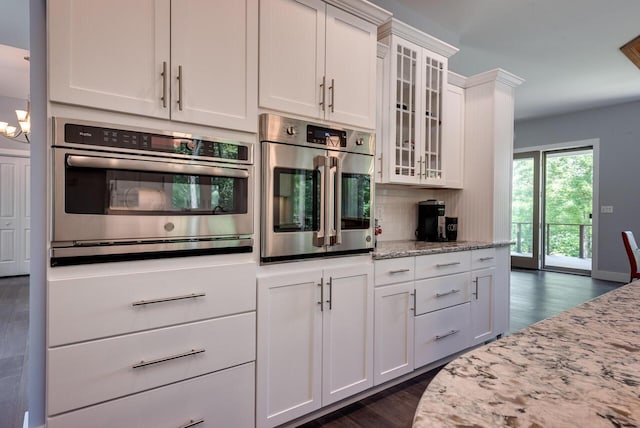 177 Wolf Hollow Rd, Lake Harmony, PA 18624 - kitchen featuring white cabinets, backsplash, light stone countertops, and oven