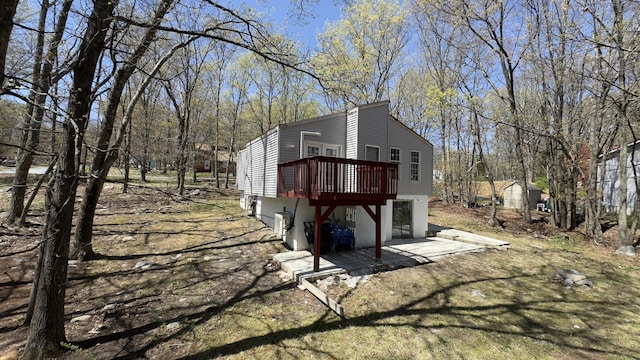 view of property exterior with a wooden deck