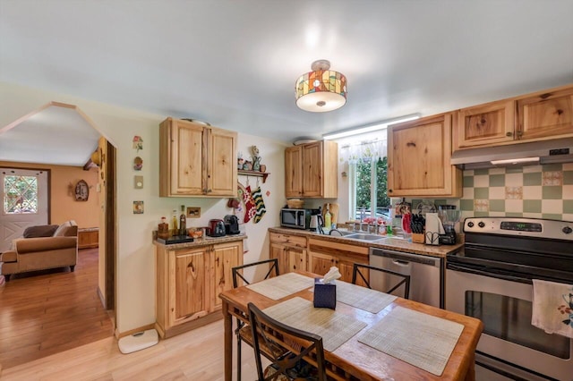 2459 Overlook Ln, Pocono Pines, PA 18350 - kitchen with stainless steel appliances, under cabinet range hood, plenty of natural light, and light wood-type flooring