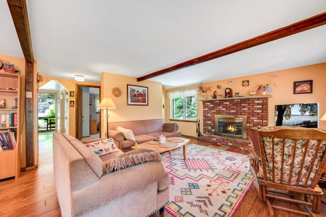 2459 Overlook Ln, Pocono Pines, PA 18350 - living room featuring beamed ceiling, a fireplace, and light wood-style flooring