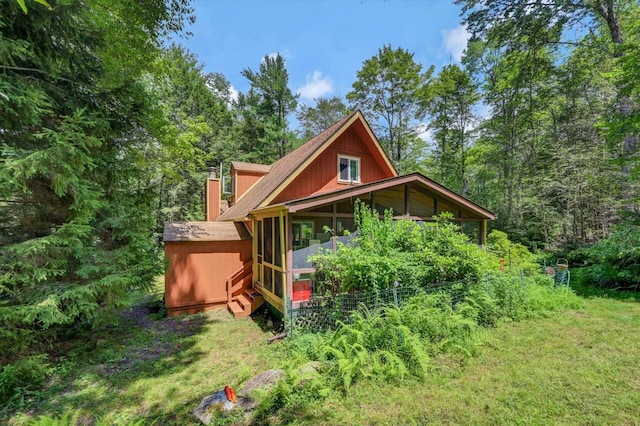 2459 Overlook Ln, Pocono Pines, PA 18350 - back of house with a chimney, a sunroom, and a forest view