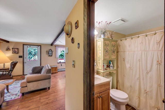 2459 Overlook Ln, Pocono Pines, PA 18350 - full bathroom with vanity, wood finished floors, a shower with shower curtain, and a baseboard radiator