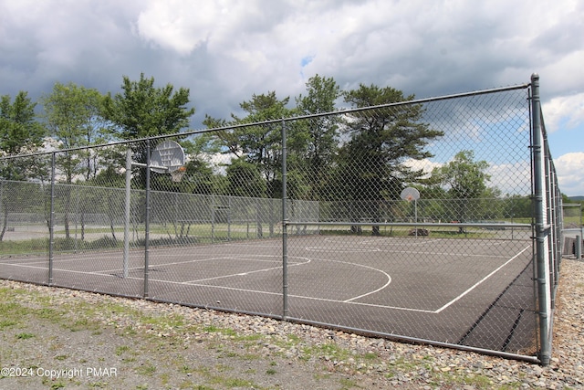 view of basketball court featuring community basketball court and fence