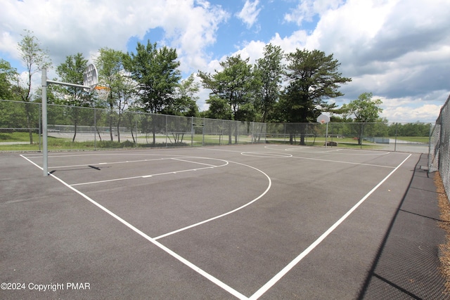 view of basketball court with community basketball court and fence