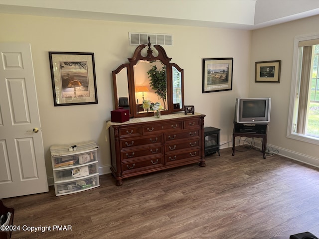 living area with visible vents, baseboards, and dark wood-style flooring