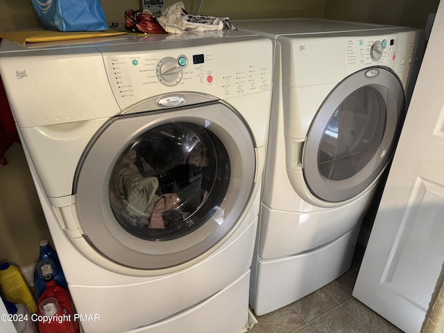 clothes washing area with independent washer and dryer, laundry area, and tile patterned flooring