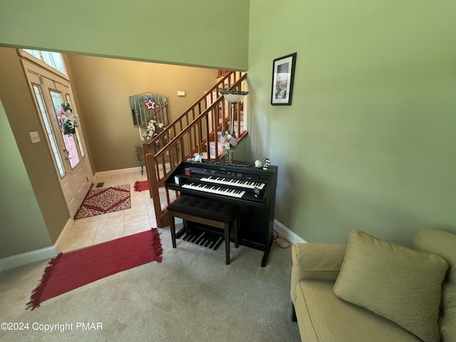 entryway with tile patterned flooring, stairway, carpet, and baseboards