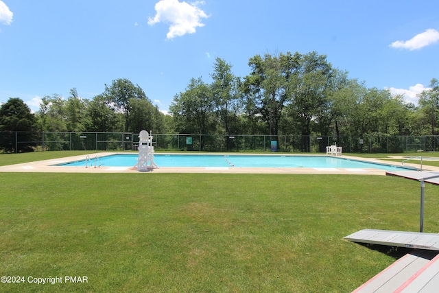 pool with a lawn and fence