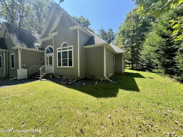 view of side of home with a yard