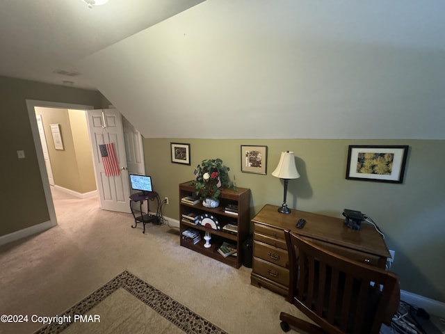 carpeted office space with baseboards, lofted ceiling, and visible vents