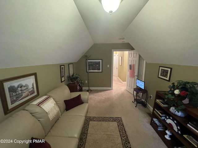 carpeted living area with baseboards and vaulted ceiling