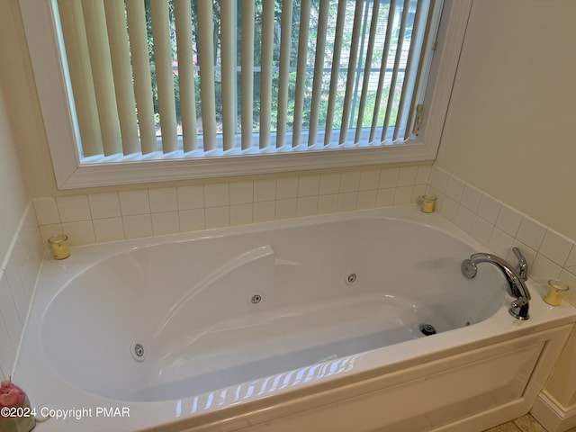 full bathroom with a whirlpool tub