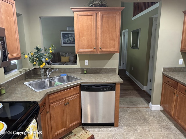 kitchen with a sink, visible vents, brown cabinets, and dishwasher