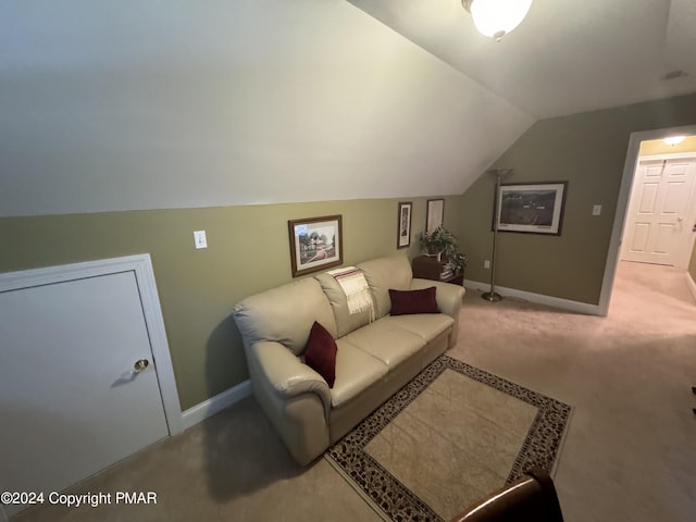 living area featuring baseboards, carpet, and vaulted ceiling