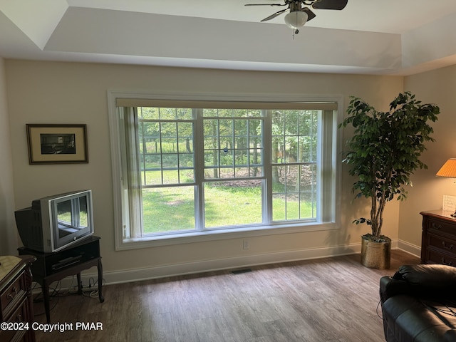 sitting room with a healthy amount of sunlight, baseboards, ceiling fan, and wood finished floors