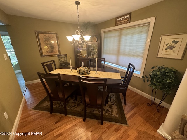 dining room with an inviting chandelier, wood finished floors, and baseboards