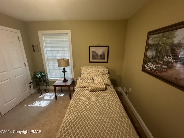 bedroom featuring baseboards and carpet floors