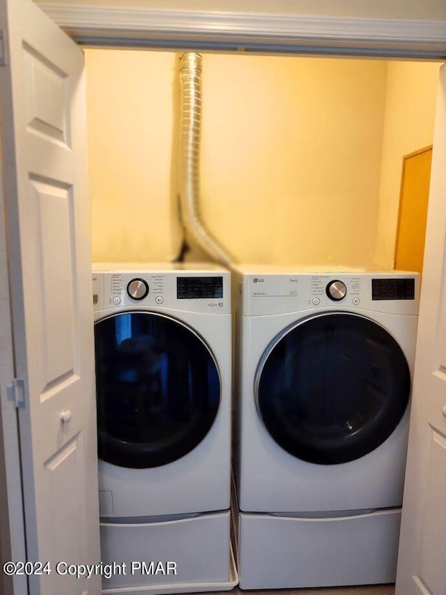 laundry room featuring laundry area and washing machine and clothes dryer