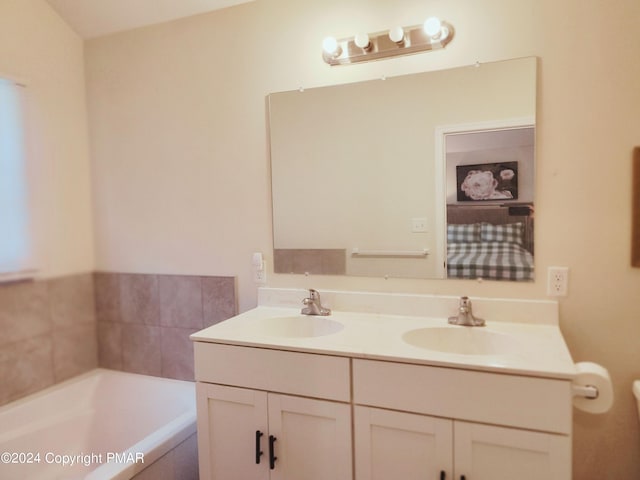 full bath featuring a garden tub, a sink, and double vanity