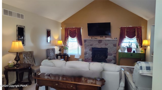 living room featuring visible vents, vaulted ceiling, and a stone fireplace