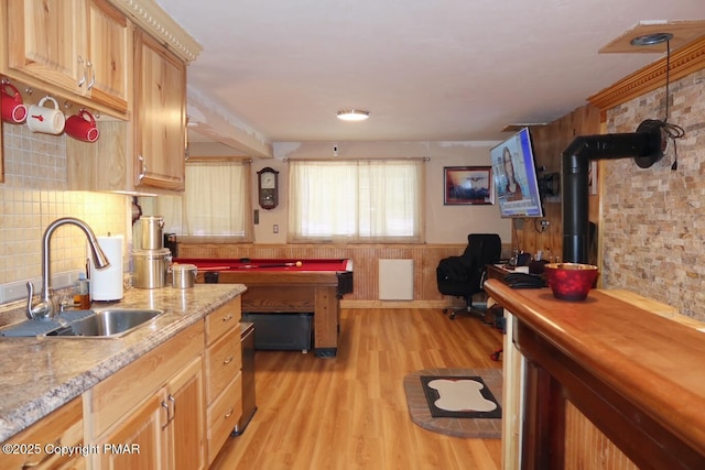 kitchen featuring a wainscoted wall, pool table, a sink, backsplash, and light wood finished floors