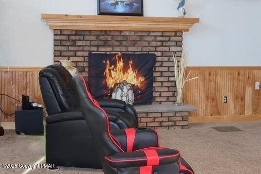 interior space featuring carpet flooring, a fireplace, and wood walls