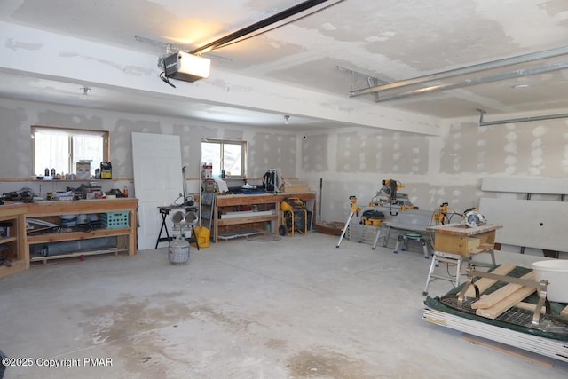 garage featuring a garage door opener and a workshop area